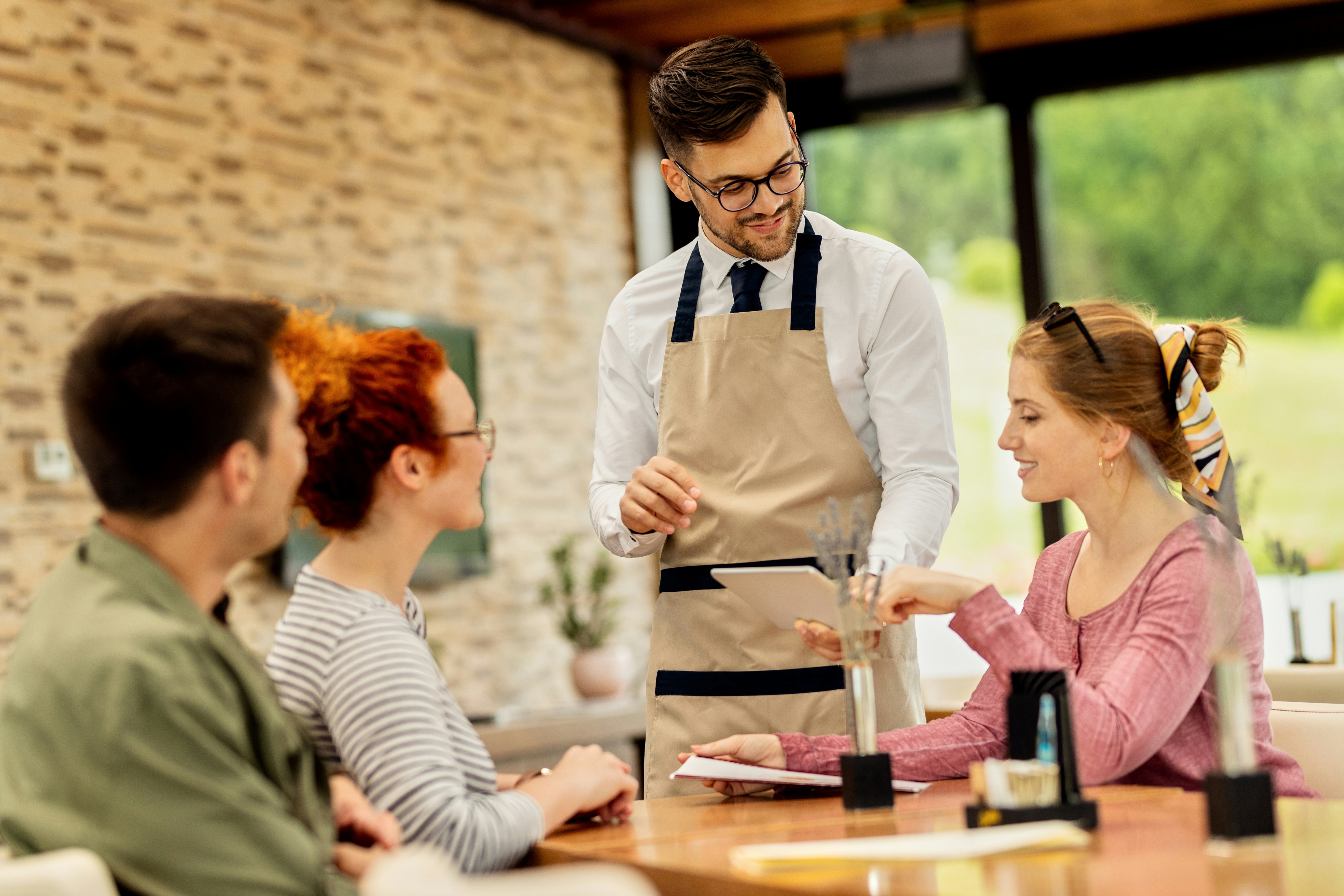 Restaurant staff coordinating service with Smart Dining at the host stand